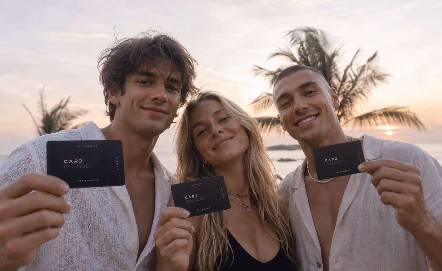 Friends on the beach holding their Phú Quốc Cards